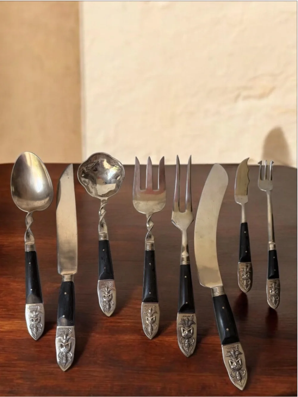 set consists of vintage Thai brass or bronze utensils with dark wooden handles.